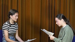 Two girls holding scripts